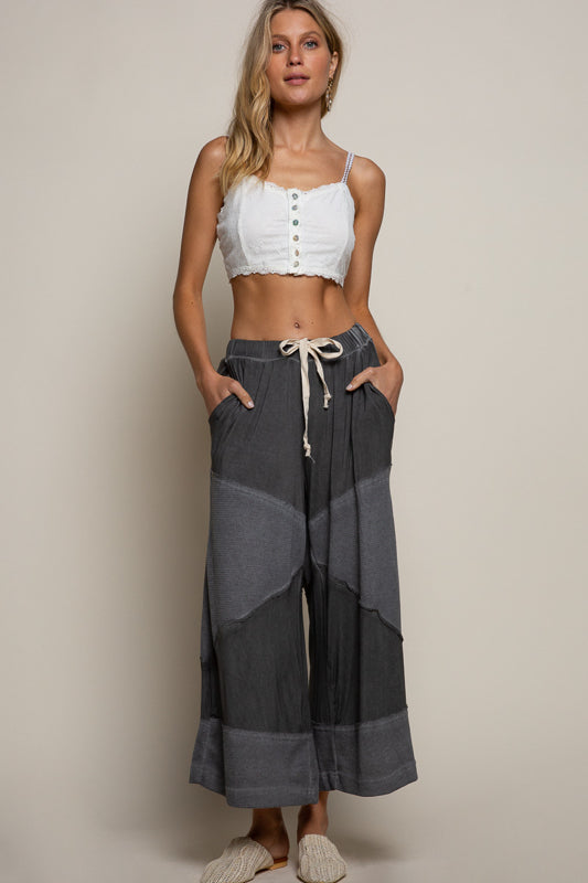 black ribbed culotte pants, elastic waist knit pants, contrast panel wide leg pants, relaxed fit cropped culottes, boutique lounge pants women, wide leg casual knit trousers, elastic drawstring culottes, modern boho lounge pants, black cropped wide leg pants, boutique fashion pants women, cozy chic culottes, knit ribbed detail pants