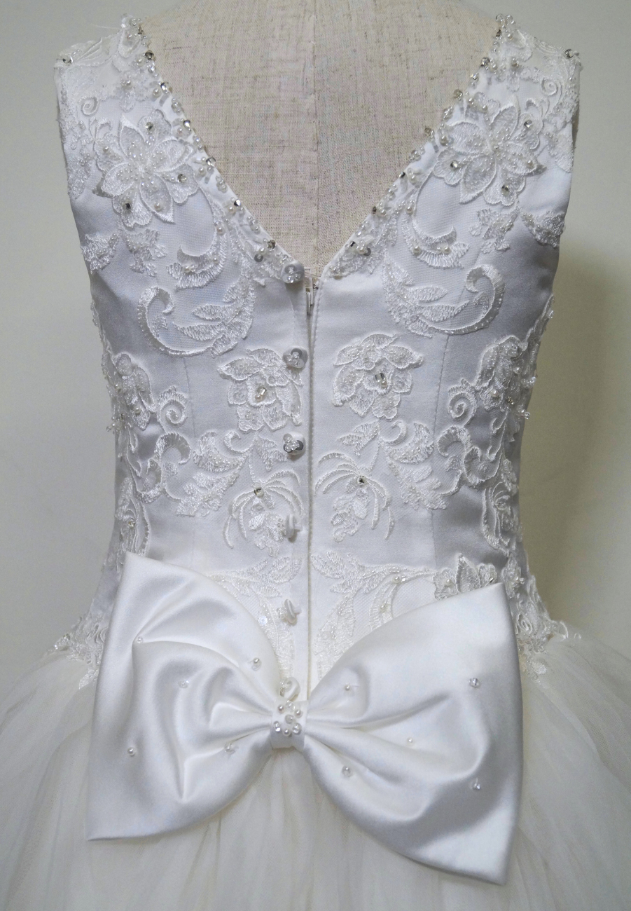 one of a kind communion dress Expressions Boutique NY, lace ruffled tulle communion gown, white first communion dress, boutique communion wear Long Island, elegant layered tulle gown for girls, handmade communion dress Woodbury NY