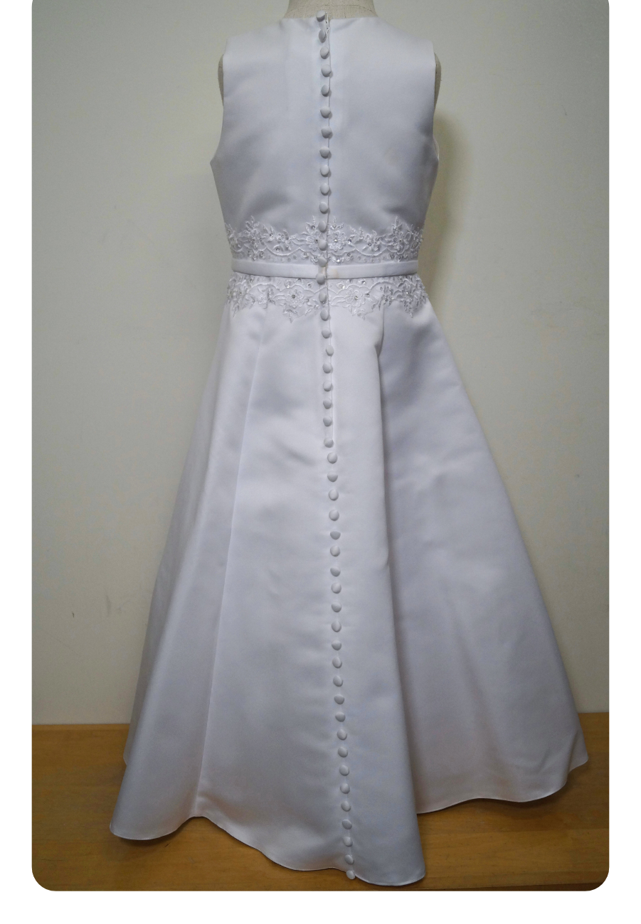 matted satin communion dress Expressions Boutique NY, girls white communion gown, sleeveless satin A-line dress, first communion attire Long Island, boutique communion wear Woodbury NY, elegant satin communion dress