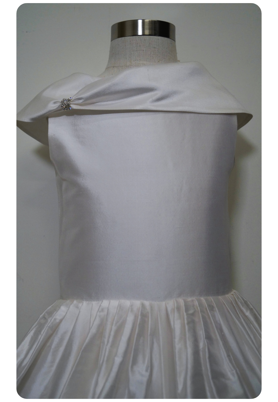 one of a kind satin communion dress Expressions Boutique NY, ruched satin communion gown, white pearl detail first communion dress, boutique communion wear Long Island, elegant satin ball gown for girls, special occasion dress Woodbury NY