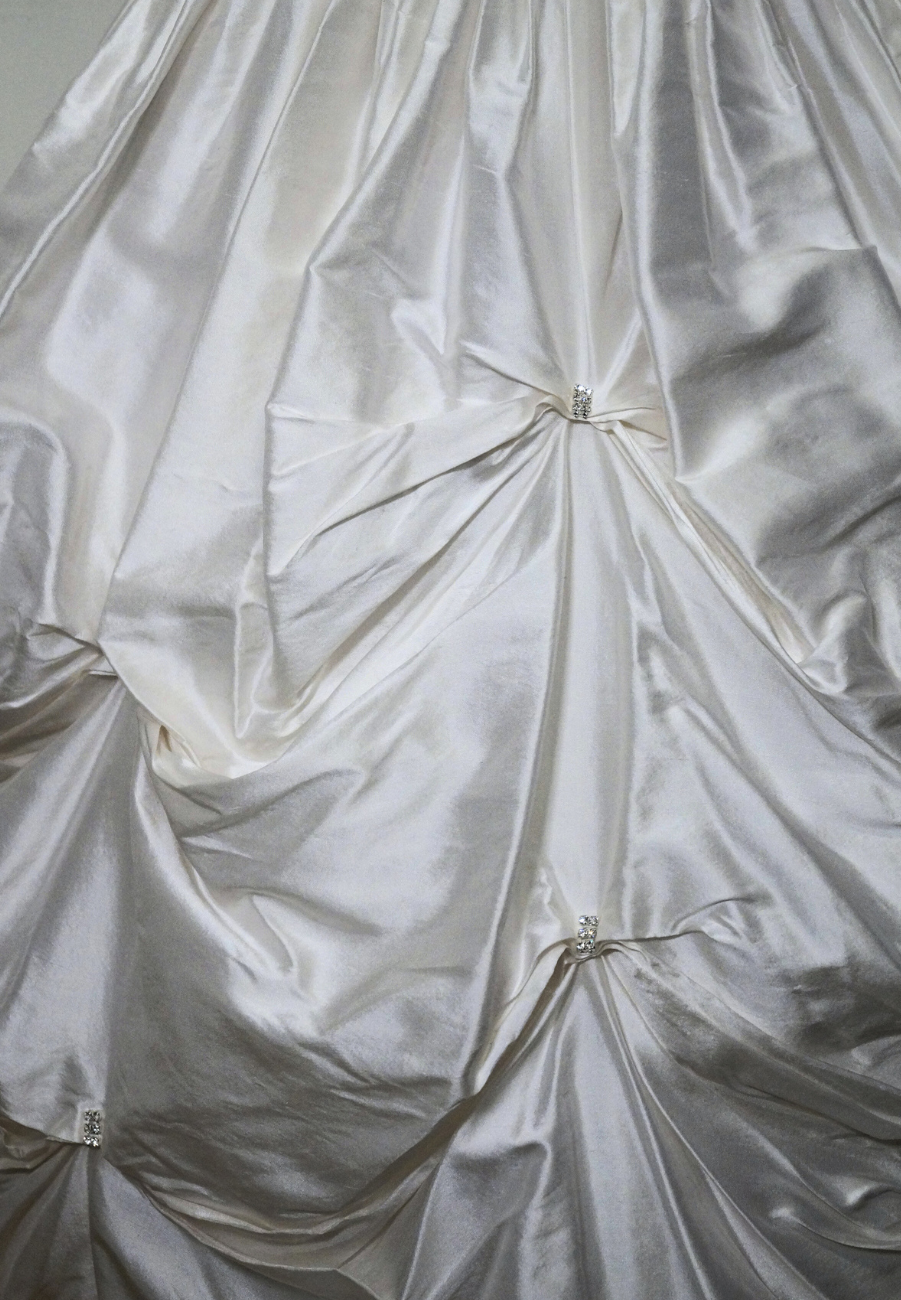 one of a kind satin communion dress Expressions Boutique NY, ruched satin communion gown, white pearl detail first communion dress, boutique communion wear Long Island, elegant satin ball gown for girls, special occasion dress Woodbury NY