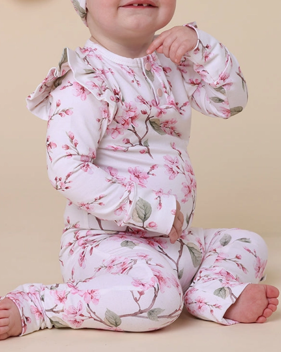 Cherry Blossom Organic Growsuit, Expressions Boutique, Women and childrens boutique, Woodbury, cherry blossom baby romper, floral organic growsuit, baby girl flower outfit, boutique infant romper, eco friendly baby clothes, newborn cherry blossom footie, baby shower gift girl, soft cotton floral sleeper, baby girl ruffle romper, spring print baby outfit