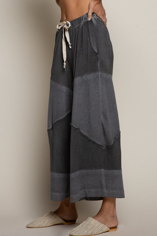 black ribbed culotte pants, elastic waist knit pants, contrast panel wide leg pants, relaxed fit cropped culottes, boutique lounge pants women, wide leg casual knit trousers, elastic drawstring culottes, modern boho lounge pants, black cropped wide leg pants, boutique fashion pants women, cozy chic culottes, knit ribbed detail pants