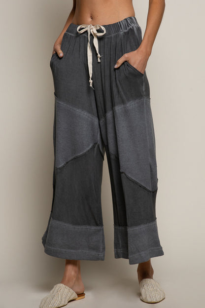 black ribbed culotte pants, elastic waist knit pants, contrast panel wide leg pants, relaxed fit cropped culottes, boutique lounge pants women, wide leg casual knit trousers, elastic drawstring culottes, modern boho lounge pants, black cropped wide leg pants, boutique fashion pants women, cozy chic culottes, knit ribbed detail pants