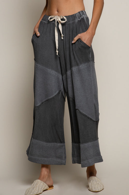 black ribbed culotte pants, elastic waist knit pants, contrast panel wide leg pants, relaxed fit cropped culottes, boutique lounge pants women, wide leg casual knit trousers, elastic drawstring culottes, modern boho lounge pants, black cropped wide leg pants, boutique fashion pants women, cozy chic culottes, knit ribbed detail pants