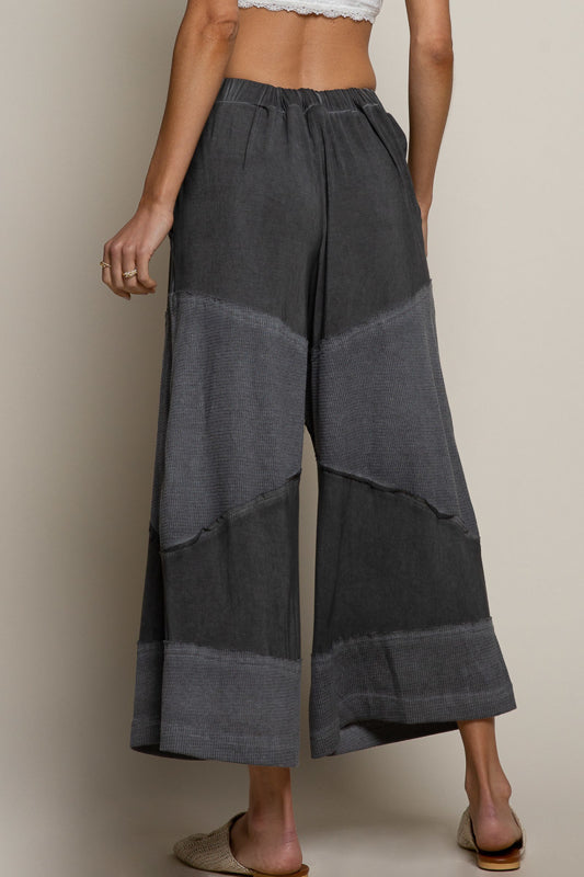 black ribbed culotte pants, elastic waist knit pants, contrast panel wide leg pants, relaxed fit cropped culottes, boutique lounge pants women, wide leg casual knit trousers, elastic drawstring culottes, modern boho lounge pants, black cropped wide leg pants, boutique fashion pants women, cozy chic culottes, knit ribbed detail pants