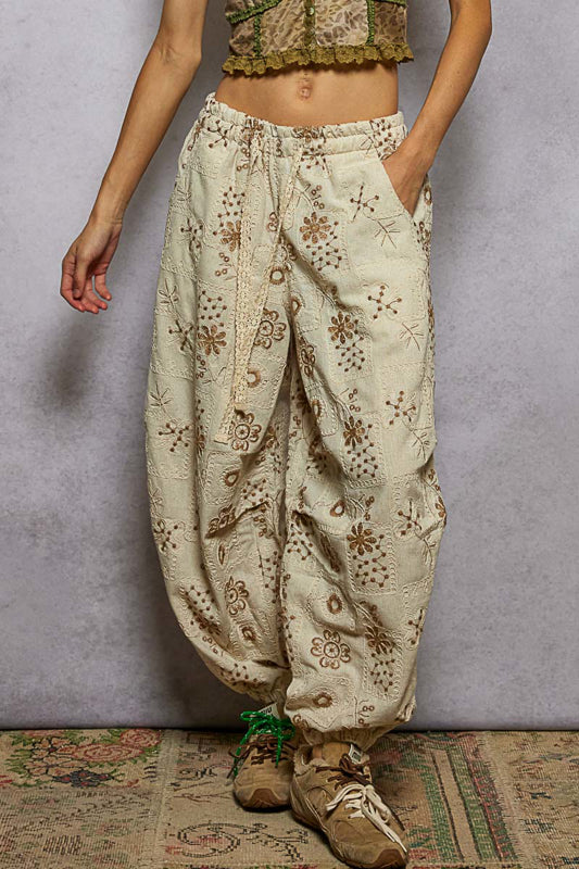 floral embroidered jogger pants, quilted jogger pants women, boho embroidered pants, boutique joggers women, natural floral print joggers, relaxed fit embroidered pants, trendy quilted jogger trousers, women’s boho lounge pants, boutique streetwear joggers, artisan embroidered pants