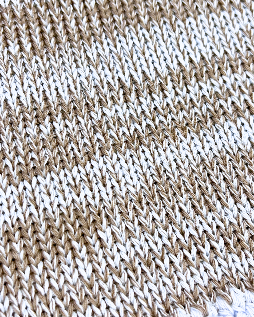 Close-up of a brown and white knitted fabric pattern