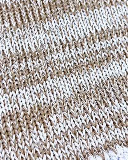Close-up of a brown and white knitted fabric pattern