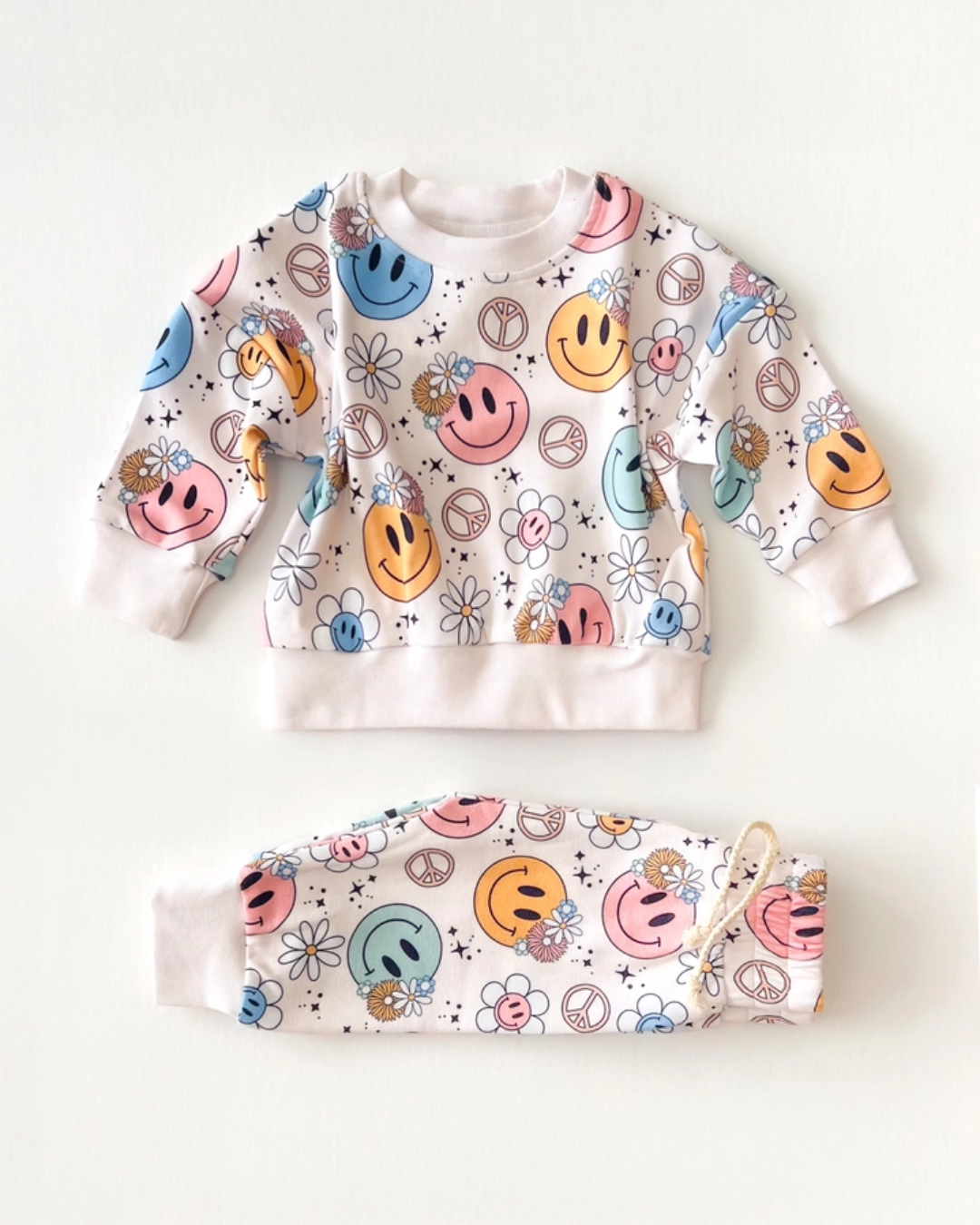 2pc jogger set kids, smiley face jogger outfit, peace sign kids clothing, daisy print kids set, retro kids jogger outfit, pastel toddler loungewear, boutique kids jogger set, groovy girl jogger set, girls matching jogger outfit, trendy toddler lounge set, back to school clothes, school outfits, pre-k clothing
