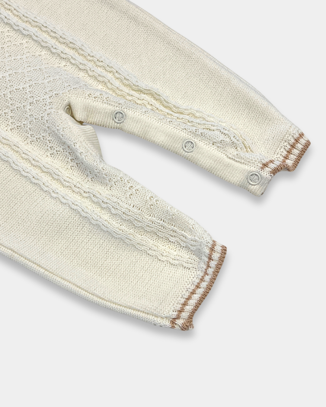 baby boy off white knit romper, cream romper with tan trim, boutique knit baby clothing, baby boy christening romper, newborn heirloom romper, neutral baby knit outfit, baby boy holiday outfit knit, boutique romper boy neutral, classic knit baby clothing, Expressions Boutique NY, Woodbury baby boutique, elegant baby boy romper