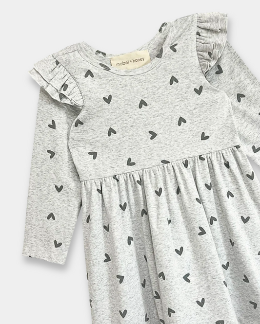 heart print toddler dress, girls grey dress with hearts, boutique toddler clothing, long sleeve ruffle dress, playful toddler girl outfit, kids boutique fashion, cozy toddler dress, everyday toddler outfits, boutique fall dresses for kids, stylish girls clothing, pre-k outfits, school picture day dress