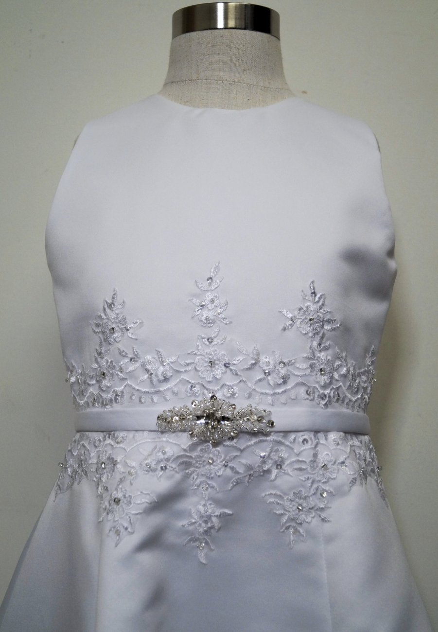 matted satin communion dress Expressions Boutique NY, girls white communion gown, sleeveless satin A-line dress, first communion attire Long Island, boutique communion wear Woodbury NY, elegant satin communion dress