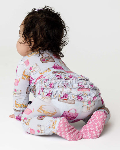 Baby wearing a patterned onesie with a white background