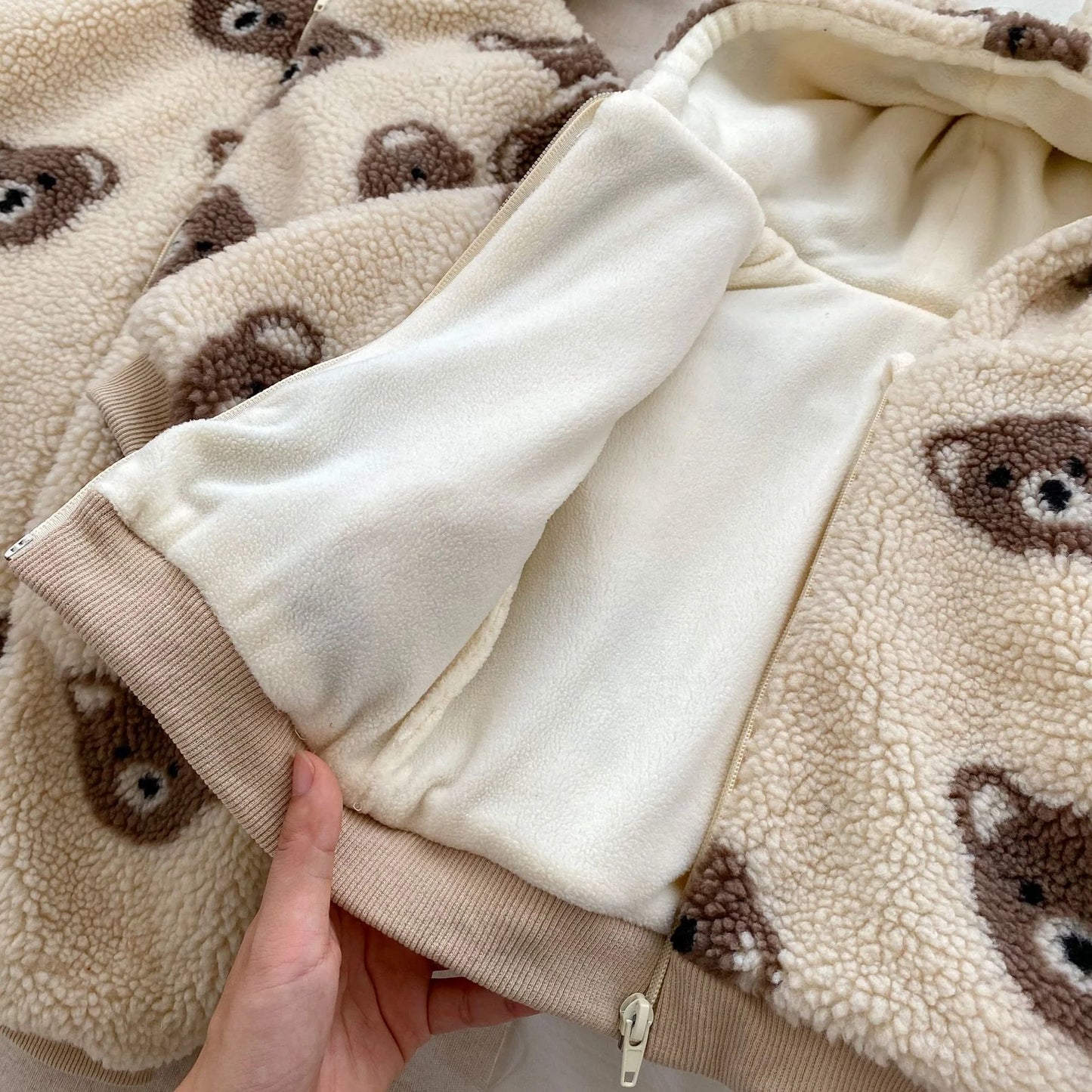 bear plush coat baby, toddler teddy bear jacket, sherpa fleece kids coat, baby bear ear hoodie, plush winter coat for toddlers, boutique bear zip-up jacket, cozy baby outerwear, teddy print kids coat, infant fleece bear hoodie, warm toddler plush jacket