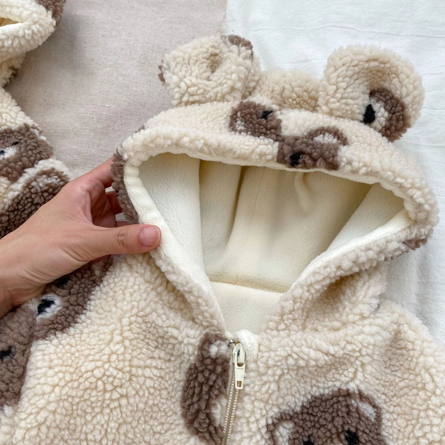 bear plush coat baby, toddler teddy bear jacket, sherpa fleece kids coat, baby bear ear hoodie, plush winter coat for toddlers, boutique bear zip-up jacket, cozy baby outerwear, teddy print kids coat, infant fleece bear hoodie, warm toddler plush jacket